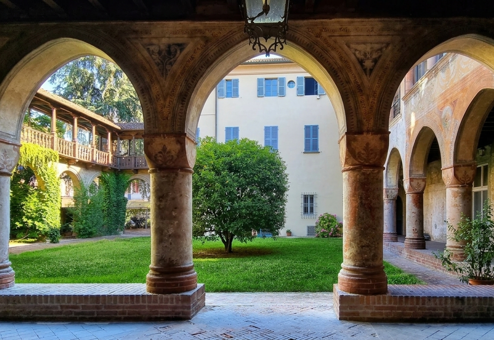 The Renaissance courtyard of Palazzo Anna d'Alencon with brick columns and pointed arches