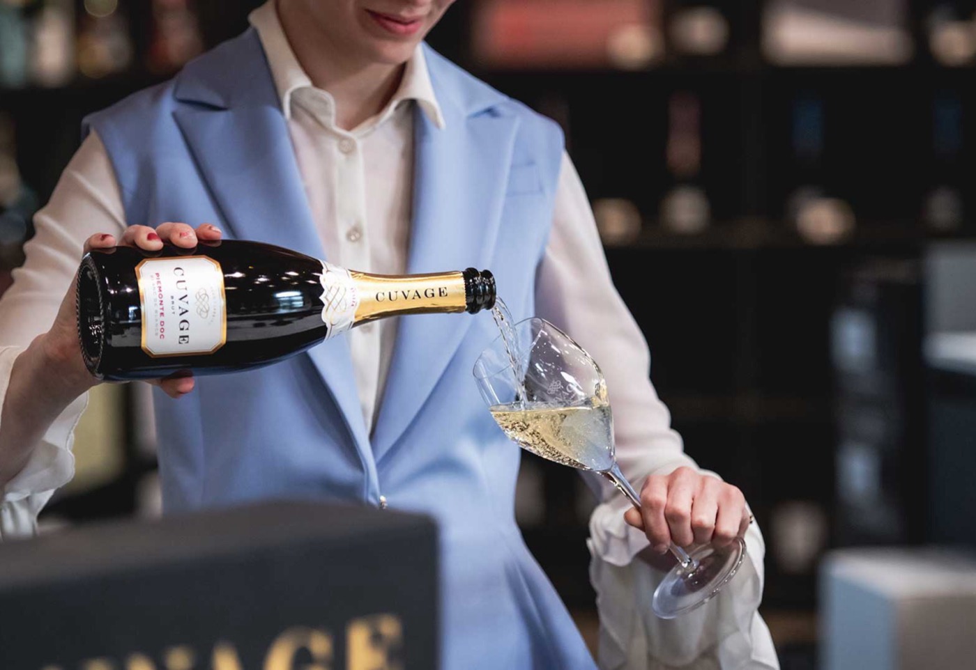 Pouring Cuvage sparkling wine in the boutique at Acqui Terme