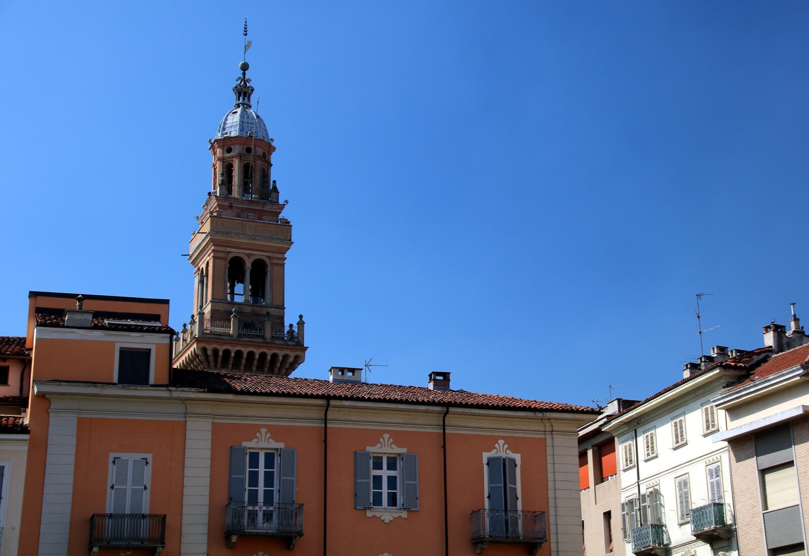 The old town of Casale Monferrato with the civic tower rising above honey-coloured palazzi